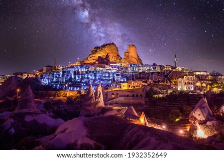 Uchisar Castle at night. It`s small, but beautiful town in Cappadocia, Turkey near Goreme. One of the best viewpoints to the valley. Colorful lights. Royalty-Free Stock Photo #1932352649