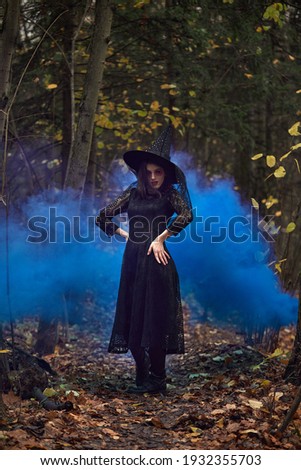 Fashion photo of woman with with creative make up in a forest. Fantasy