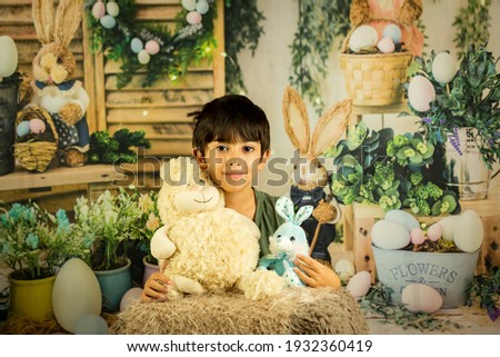 Boy with rabbits on background of Easter rabbits. Easter celebration