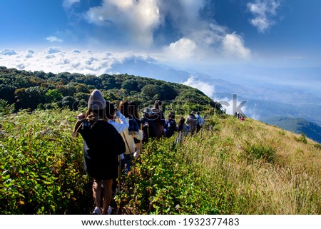 Group of people walking on mountain in morning sunrise, trekking on the Kew Mae Parn,Inthanon National Park mountain in Thailand. Royalty-Free Stock Photo #1932377483
