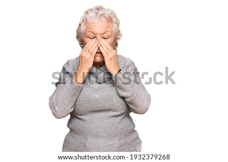 Senior grey-haired woman wearing casual winter sweater rubbing eyes for fatigue and headache, sleepy and tired expression. vision problem 