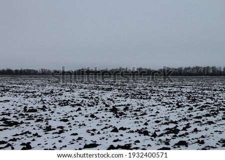 Snow covered agricultural field in the bad weather