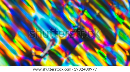 Out of focus photo lens overlays heavy grain noise abstract hologram vivid colorful texture background.