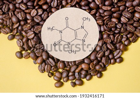 Structural chemical formula of caffeine molecule with roasted coffee beans. Caffeine is a central nervous system stimulant, psychoactive drug molecule. Royalty-Free Stock Photo #1932416171
