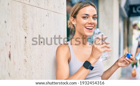 Young cauciasian fitness woman wearing sport clothes training outdoors drinking fresh water Royalty-Free Stock Photo #1932454316