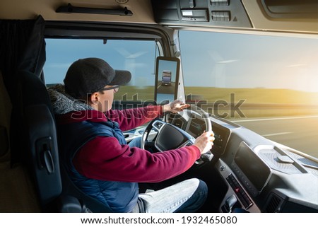 Man driving a truck with rear view camera Royalty-Free Stock Photo #1932465080