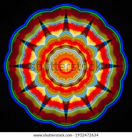 Ornament on a black background. Technically modified, abstract pattern.Fantasy color pattern in combination of red and yellow with a flower shape in the center.