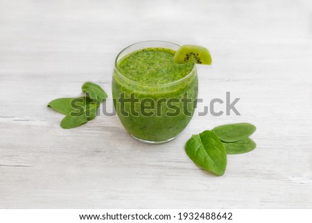 Spinach smoothie. Healthy dieting and nutrition, food and drink, vegan, vegetarian concept, healthy lifestyle. Green smoothie with organic ingredients, vegetables on a wooden table