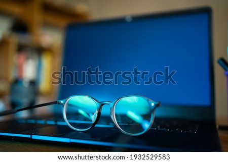 Eyeglasses with blue light filter can protect your eyes from screens. Royalty-Free Stock Photo #1932529583
