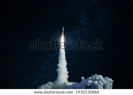 Successful launch of a space rocket into outer space. Spaceship lift off into the starry sky. Travel and exploration other planets, concept Royalty-Free Stock Photo #1932530864