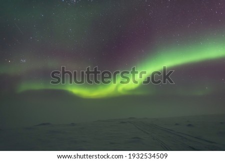 Aurora Borealis over misty lanscape