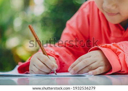 Little kids drawing cartoon with color pencil that is good activity for improve creative art and hand writing skills in children. Concept picture for education and  learning hobby.