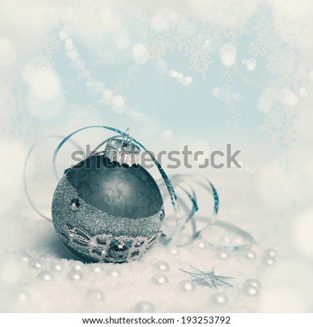 Christmas bauble on abstract winter background, text space, toned picture