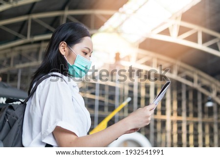 Traveler young asian woman,girl wear mask, use local map to sightseeing,city tourism while travelling in country at train station terminal. Backpacker tourist,holiday trip, summer or vacation concept.