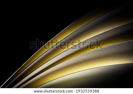 Flipping Book Pages with Yellow Light Shining Through