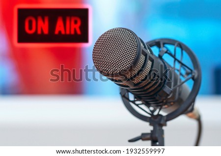 Professional microphone in radio station studio and on air sign Royalty-Free Stock Photo #1932559997