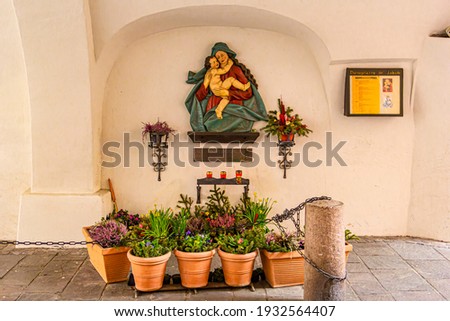 virgin mary figure on the building wall