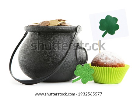 Pot of coins, cupcake and flag with picture of clover leaf isolated on white background. Concept St.Patrick's Day