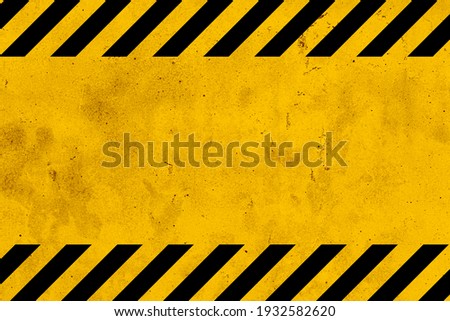 Grunge yellow and black diagonal stripes. Industrial warning background, warn caution, construction, safety Royalty-Free Stock Photo #1932582620