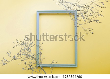 Dry grass agains with blank picture frame for quote mock-up on yellow background