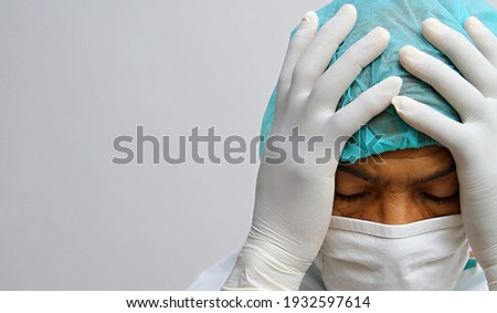 doctor under pressure with face mask and gloves in hospital with white background stock photo