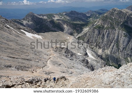 Hiking or climbing Corno Grande summit, highest mountain of Apennine Mountains, Gran Sasso National Park, Italy