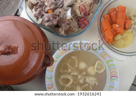 Pasta soup with meat and vegetables as typical spanish winter dish Royalty-Free Stock Photo #1932616241