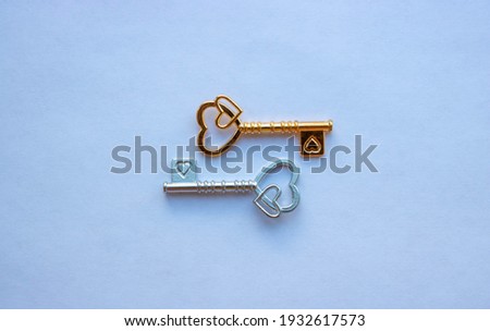 Gold and silver keys, with hearts isolated on a white background.