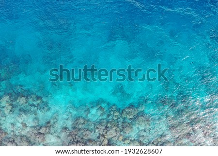 Aerial drone view of an endangered coral reef near the coast in the Maldives