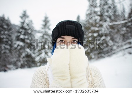 Female portrait on the background of mountains landscape. Winter