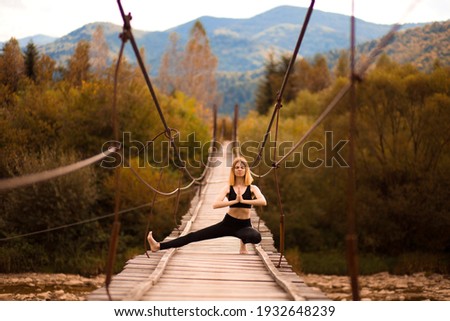 Calm of athlete woman do stretching exercise and relax in yoga pose on wooden bridge over mountain river with beautiful nature background
