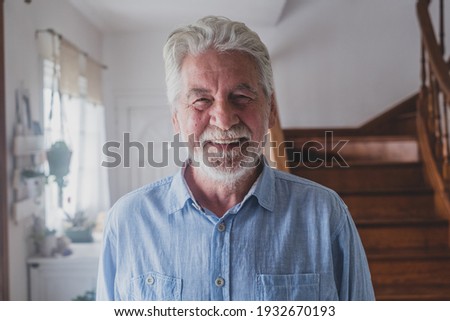 Happy old man with grey hair, senior 80s smiling with white teeth at home. Portrait of one cheerful grandfather relaxing indoor.
 Royalty-Free Stock Photo #1932670193