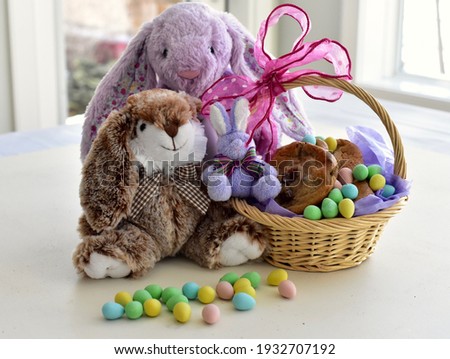 Easter Bunny treats and baskets for holiday Easter Sunday gifts for children, chocolate and stuffed toys. Photo concept, holiday, seasonal