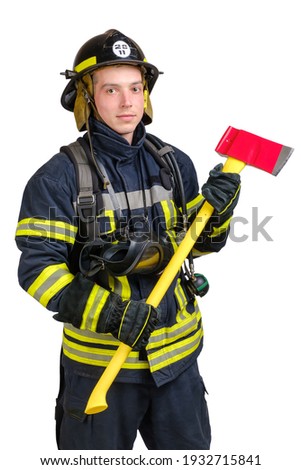 Portrait of young brave man in uniform and hard hat of fireman holds axe and looking at camera with smile isolated on white background