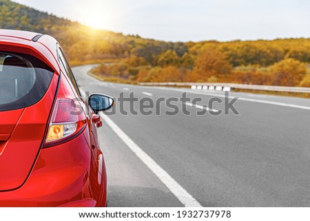 Red car on the side of the highway. Road trip. Royalty-Free Stock Photo #1932737978