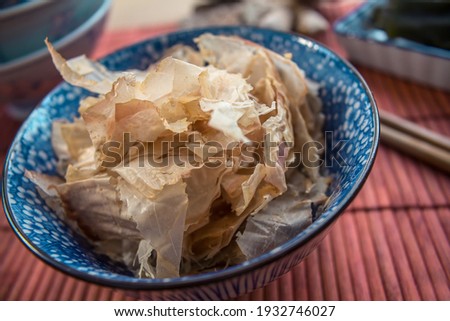 An oriental decorated bowl filled with Japanese "katzuobushi" (dried and smoked skip jack tuna flakes)