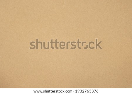Texture of brown craft or kraft paper background, cardboard sheet, recycle paper, copy space for text. Royalty-Free Stock Photo #1932763376