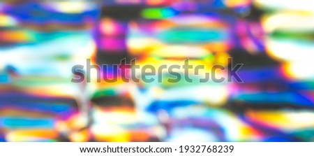 Out of focus photo lens overlays heavy grain noise abstract holographic vivid colorful texture background.