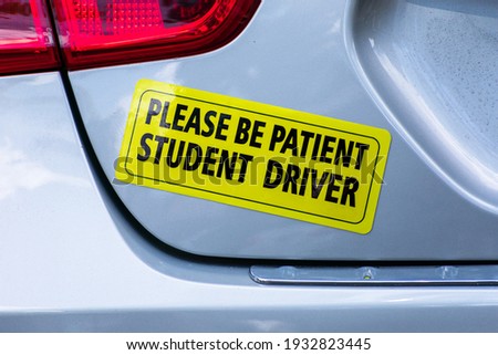 Please Be Patient Student Driver - yellow bumper sticker on the car rear door Royalty-Free Stock Photo #1932823445