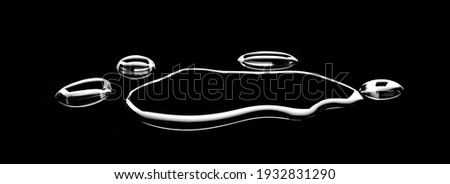 real image, spilled water drop on the floor isolated on black background. Royalty-Free Stock Photo #1932831290