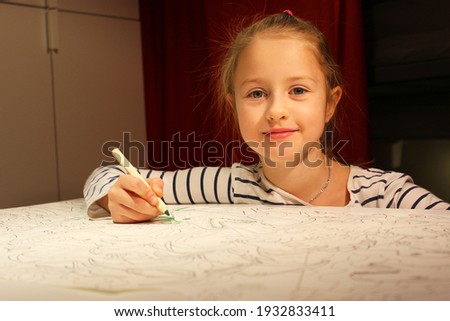 little Girl with white hair, in a striped sweater. Very passionate and serious. He paints, draws on a large sheet of white paper, using multi-colored markers or pencils. Be in your children's room.