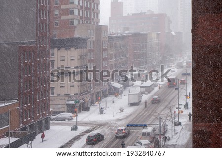 Christmas White winter snowfall day in the big apple new york city manhattan buildings streets and walkways Intersection high angle
