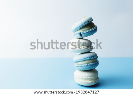 White and blue macaroons on the table, macaroons on white blue background. High quality photo