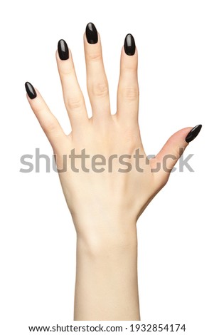 Female hand with black nails manicure.  Isolated on white background.