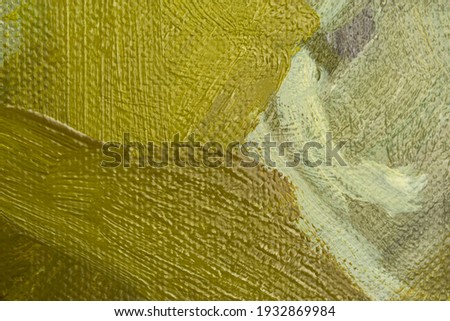 Abstract background with brown and yellow oil paint on canvas. Close-up of brushstrokes in the painting. Olive, ocher, lemon yellow paint. Handmade background design with canvas texture. Oil painting
