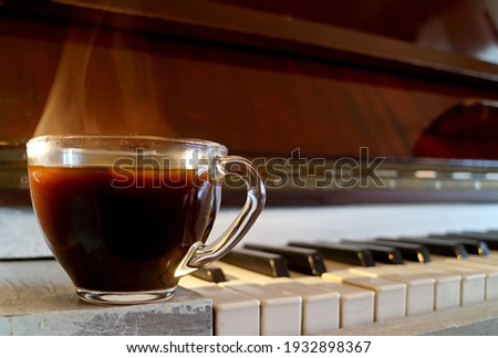 Closeup a Cup of Hot Coffee with Smoke Isolated on the Piano
