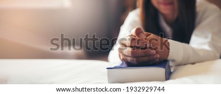 Prayer and bible concept. Hand of female praying, hope for peace and free, Hand in hand together by woman, believe and faith in christian religion at church-panoramic banner for web h