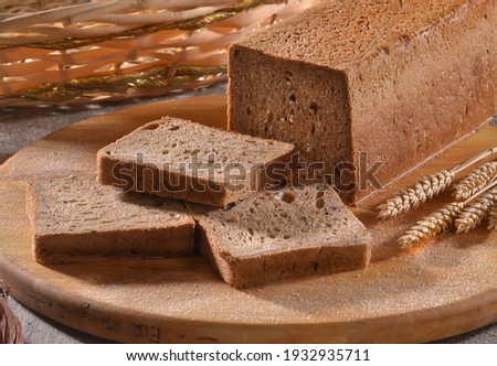 toast wheat integral bread sliced on rustic background. Royalty-Free Stock Photo #1932935711