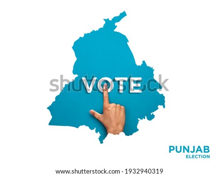 VOTE FOR INDIA PUNJAB , male Indian Voter Hand with voting sign or ink pointing out , Voting sign on finger tip Indian Voting on blue background Royalty-Free Stock Photo #1932940319