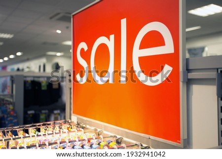 Sale sign text in clothing store marketplace, shopping in the mall, sale,business concept background close up